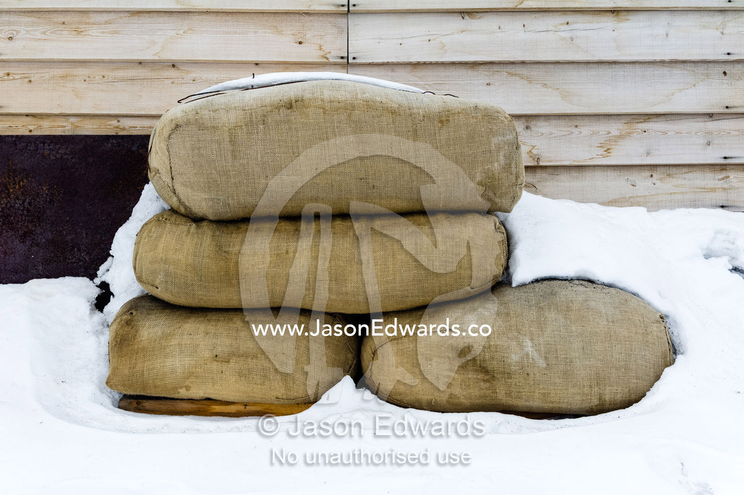 Hay bales to feed horses stacked against the wall of Antarctic explorer Robert Falcon Scott's hut. Scott's Hut, Cape Evans, Ross Island, Antarctica.