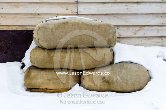 Hay bales to feed horses stacked against the wall of Antarctic explorer Robert Falcon Scott's hut. Scott's Hut, Cape Evans, Ross Island, Antarctica.