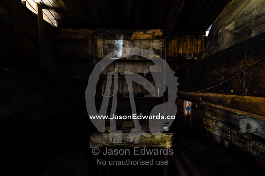A bunkroom and bookcase in the hut of Antarctic explorer Robert Falcon Scott. Scott's Hut, Cape Evans, Ross Island, Antarctica.
