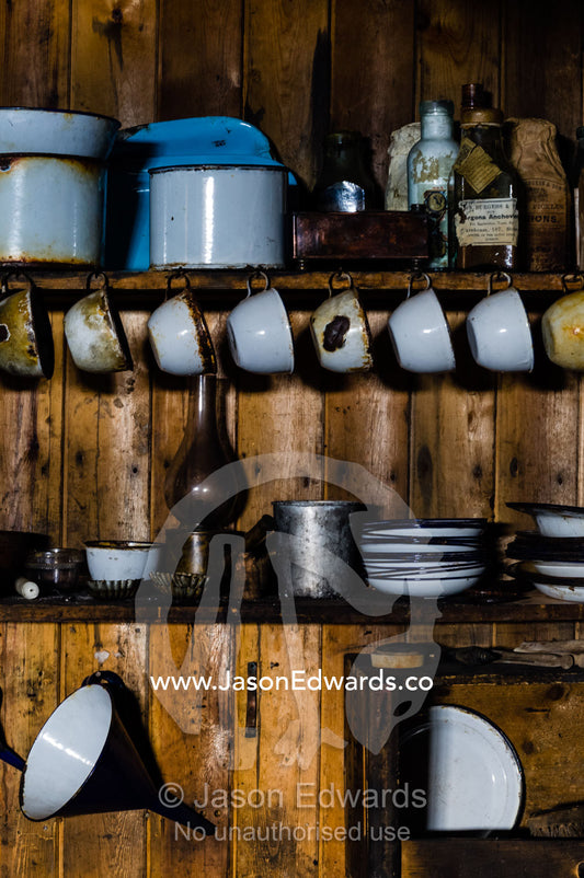 Plates, cups and kitchen utensils in the hut of Antarctic explorer Robert Falcon Scott. Scott's Hut, Cape Evans, Ross Island, Antarctica.