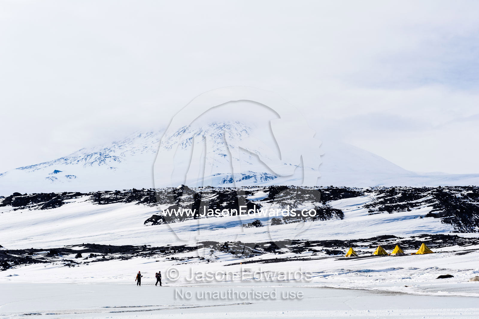 Archivists cross the sea ice to continue restoration on the Antarctic explorer Robert Falcon Scott's hut. Scott's Hut, Mount Erebus, Cape Evans, Ross Island, Antarctica.
