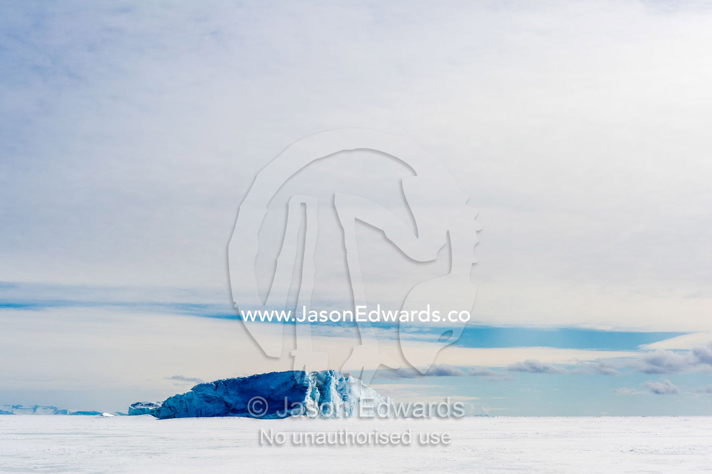 An enormous iceberg trapped in frozen sea ice. Erebus Bay, McMurdo Sound, Cape Evans, Ross Island Antarctica.