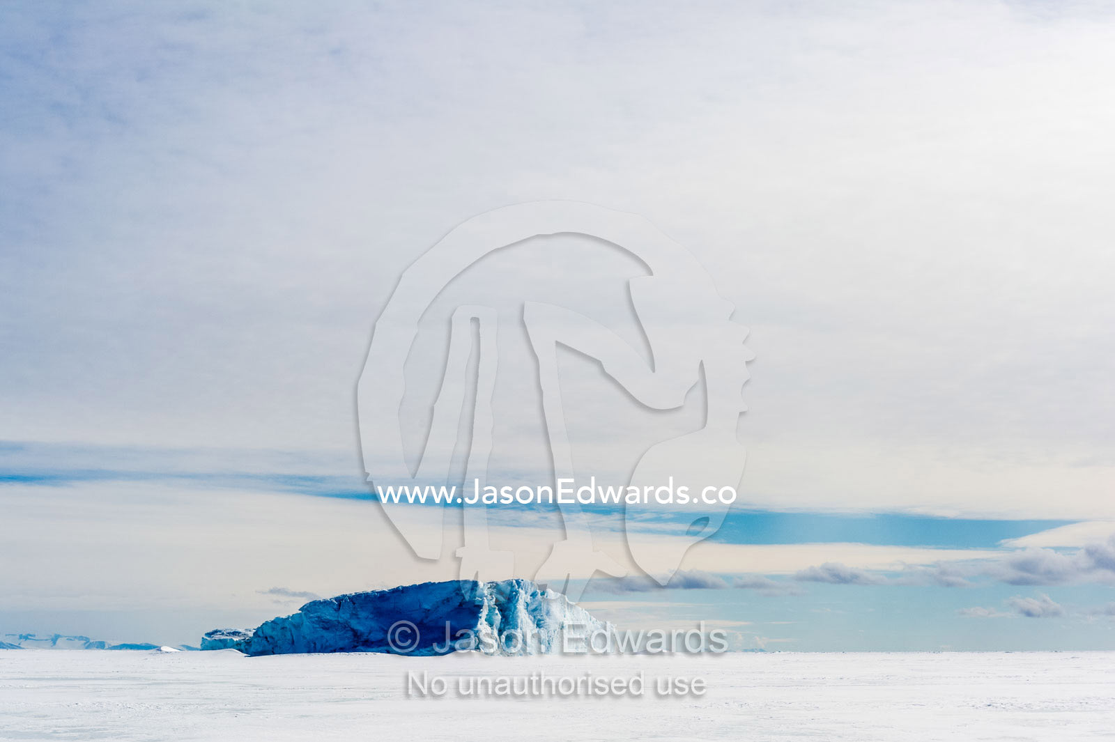 An enormous iceberg trapped in frozen sea ice. Erebus Bay, McMurdo Sound, Cape Evans, Ross Island Antarctica.