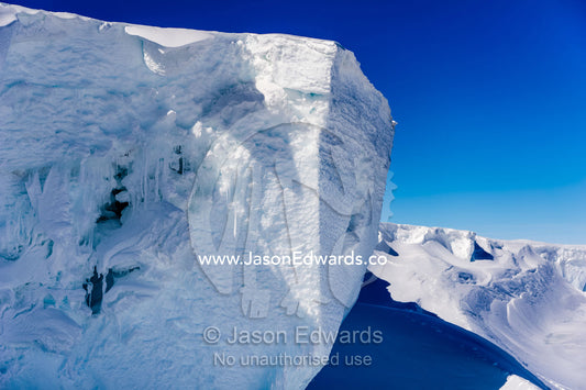 The sheer cliffs of the Erebus glacier tongue in Antarctica. Erebus Ice Caves, Mount Erebus, Ross Island, Antarctica.