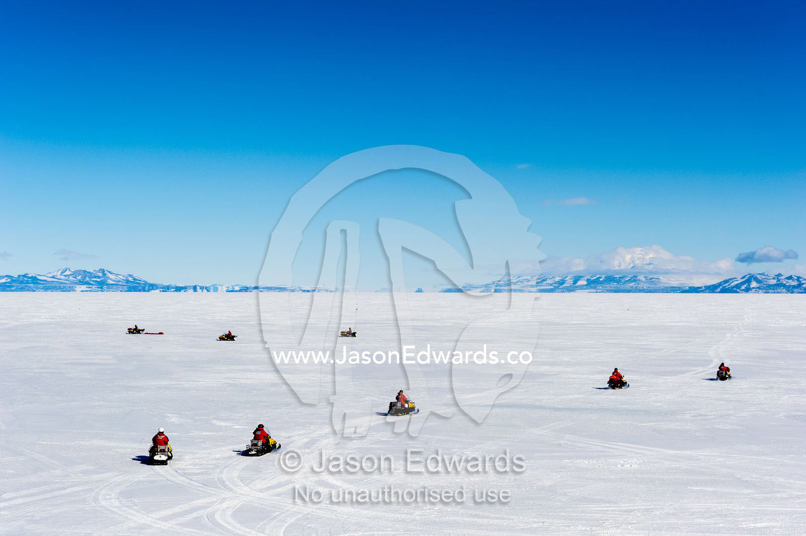 A team of skidoos crossing the frozen sea ice in Antarctica. Royal Society Range, McMurdo Sound, Ross Island, Antarctica.