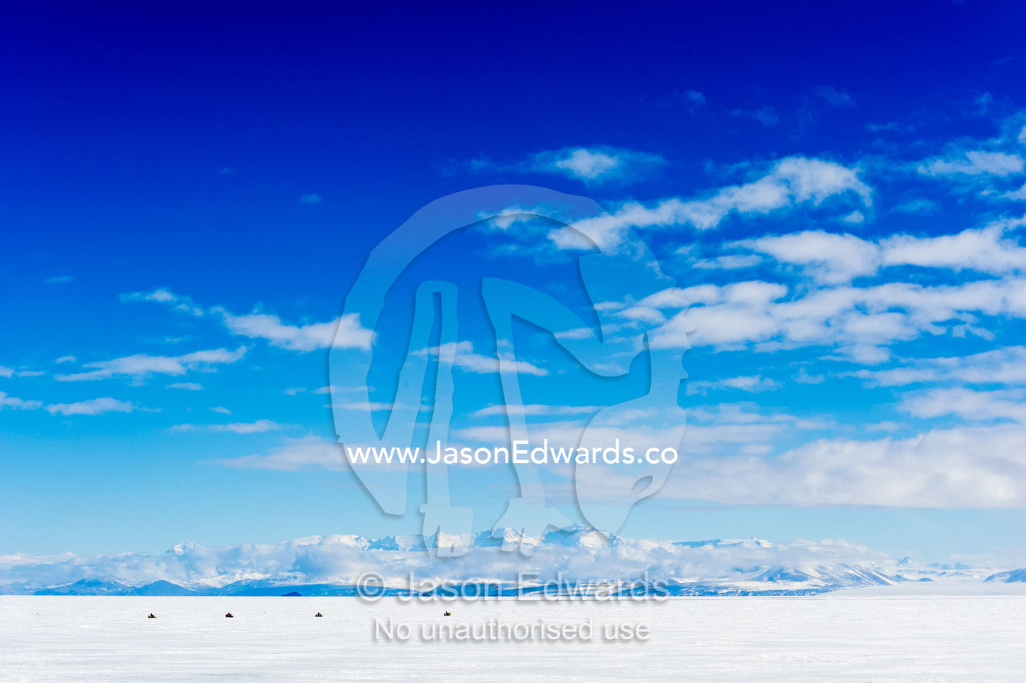A team of skidoos crossing the frozen sea ice in Antarctica. Royal Society Range, McMurdo Sound, Ross Island, Antarctica.
