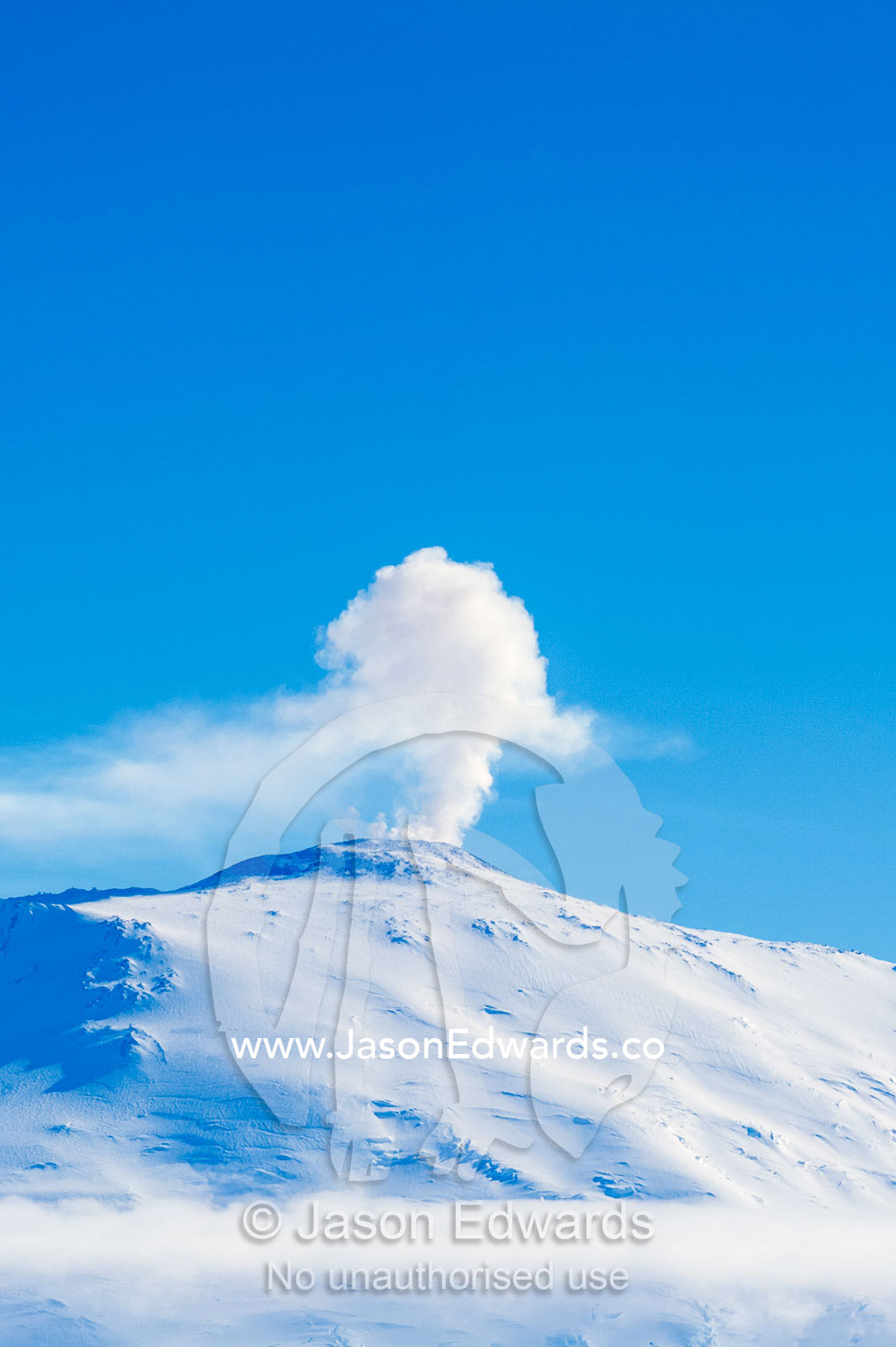 The smoking summit of Mount Erebus an active volcano in Antarctica. Mount Erebus, Ross Island, Antarctica.