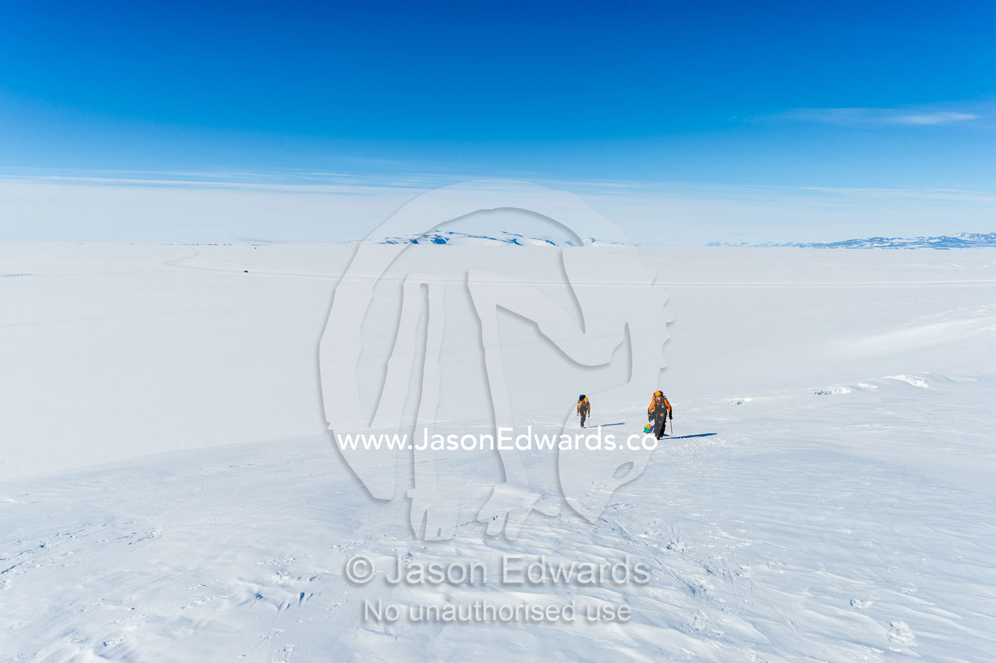 Ice guides hiking across a crevasse field on the slopes of Mount Erebus above the Ross Ice Shelf in Antarctica. Silver City Ice Fall, Hut Point Peninsula, Ross Island Antarctica.