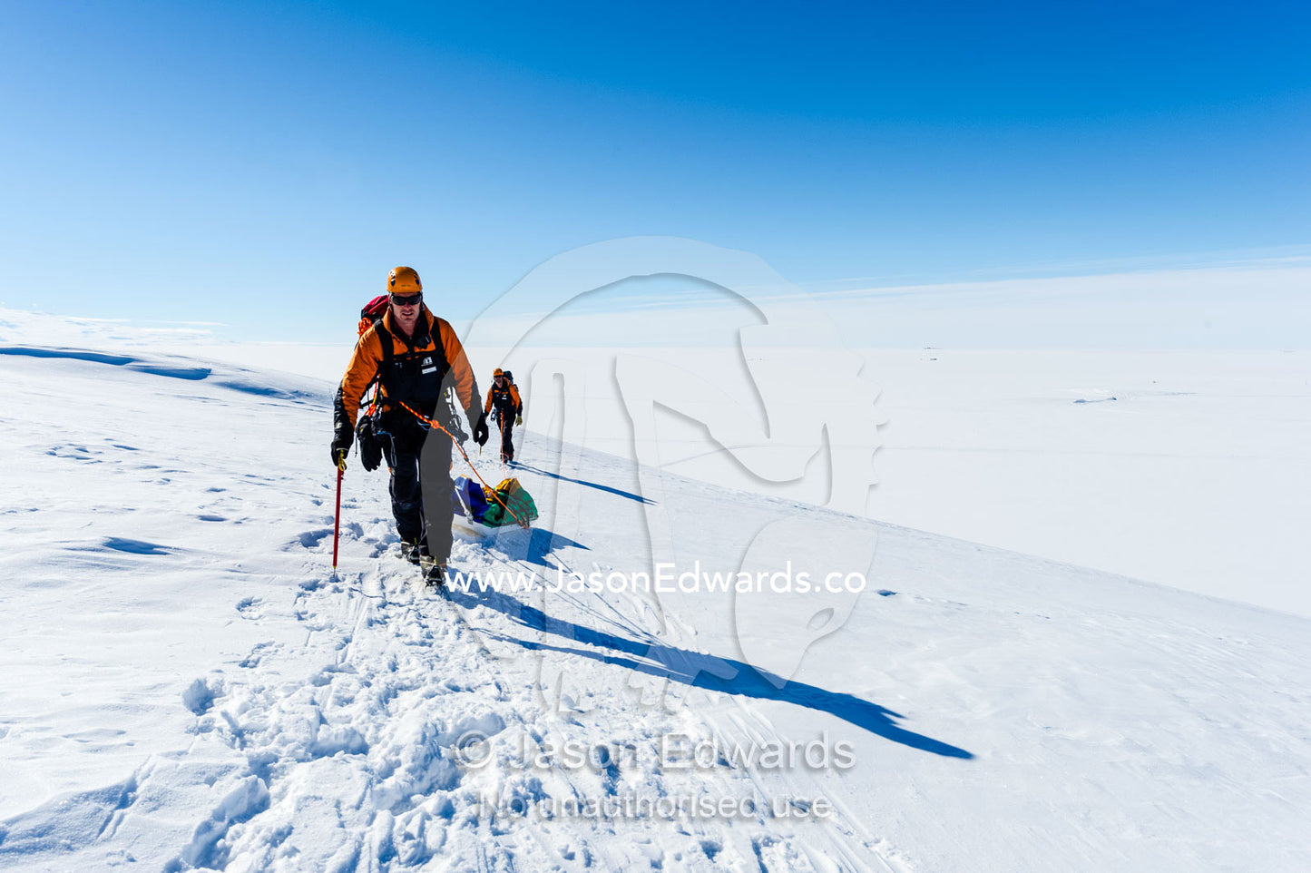Guides hiking across a crevasse field on the slopes of Mount Erebus in Antarctica. Silver City Ice Fall, Hut Point Peninsula, Ross Island Antarctica.