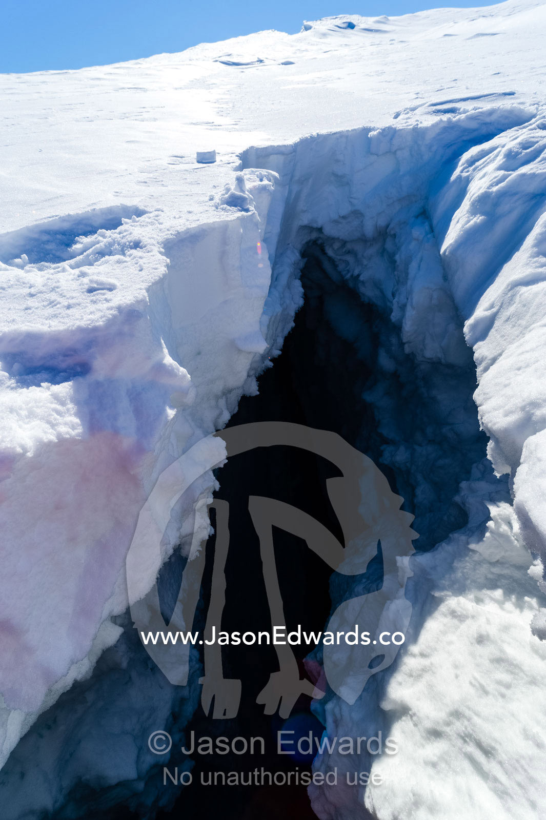 The entrance to a crevasse on the slopes of Mount Erebus in Antarctica. Silver City Ice Fall, Hut Point Peninsula, Ross Island Antarctica.