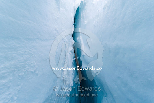 The caverness and sheer icy walls of a crevasse on the slopes of Mount Erebus in Antarctica. Silver City Ice Fall, Hut Point Peninsula, Ross Island Antarctica.