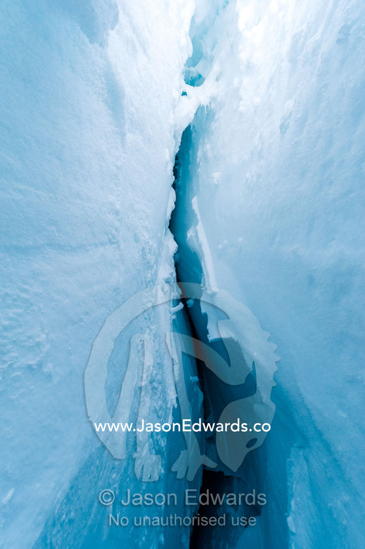 The cavernous and sheer icy walls of a crevasse on the slopes of Mount Erebus in Antarctica. Silver City Ice Fall, Hut Point Peninsula, Ross Island Antarctica.