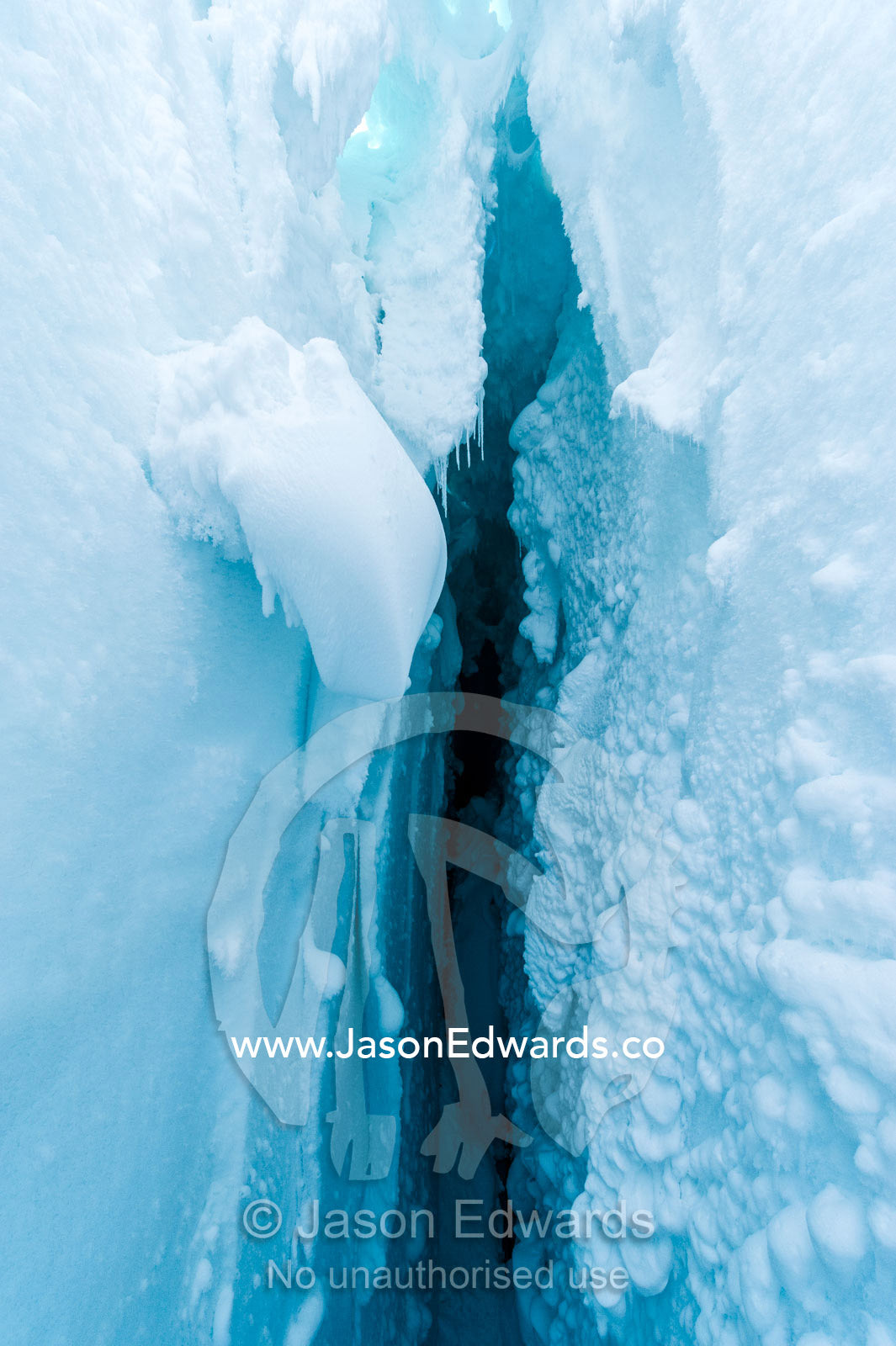 The cavernous and sheer icy walls of a crevasse on the slopes of Mount Erebus in Antarctica. Silver City Ice Fall, Hut Point Peninsula, Ross Island Antarctica.