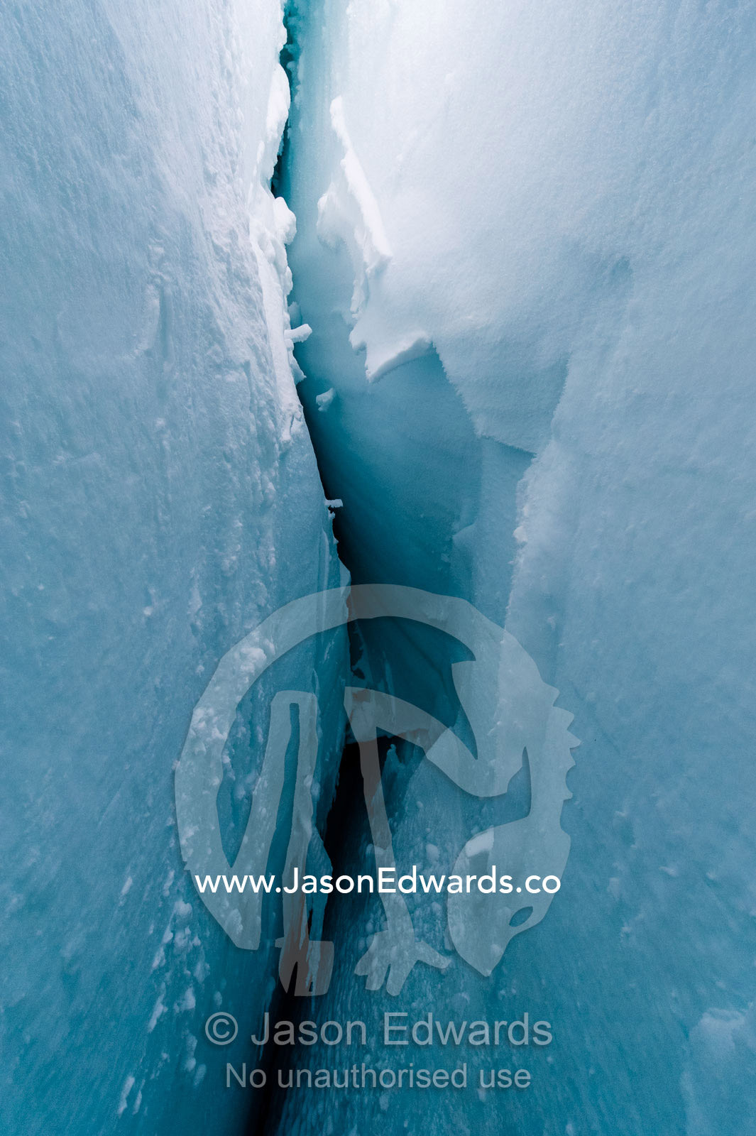 The cavernous and sheer icy walls of a crevasse on the slopes of Mount Erebus in Antarctica. Silver City Ice Fall, Hut Point Peninsula, Ross Island Antarctica.