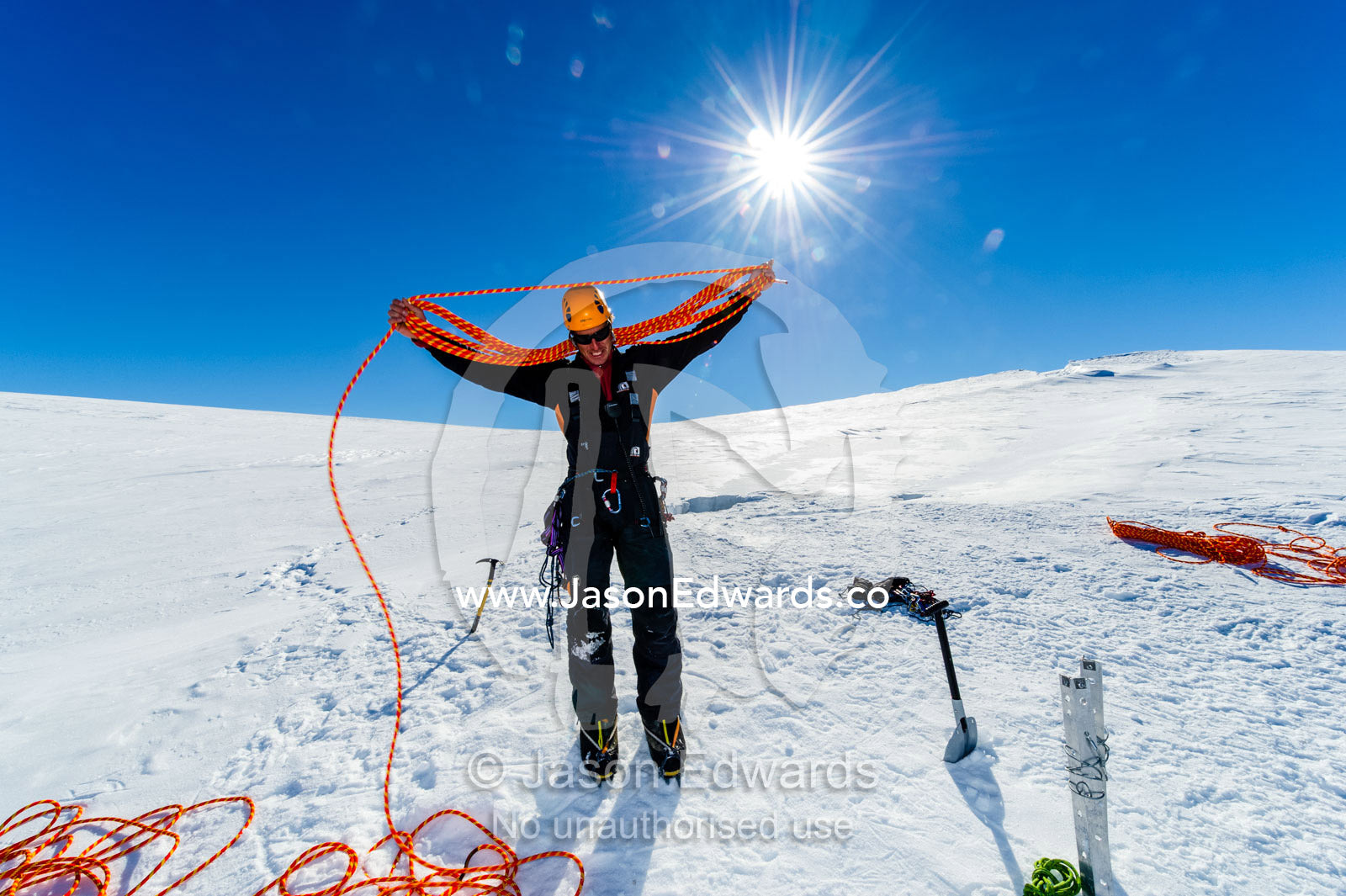 Ice guides coiling ropes after entering a crevasse on the slopes of Mount Erebus in Antarctica. Silver City Ice Fall, Hut Point Peninsula, Ross Island Antarctica.