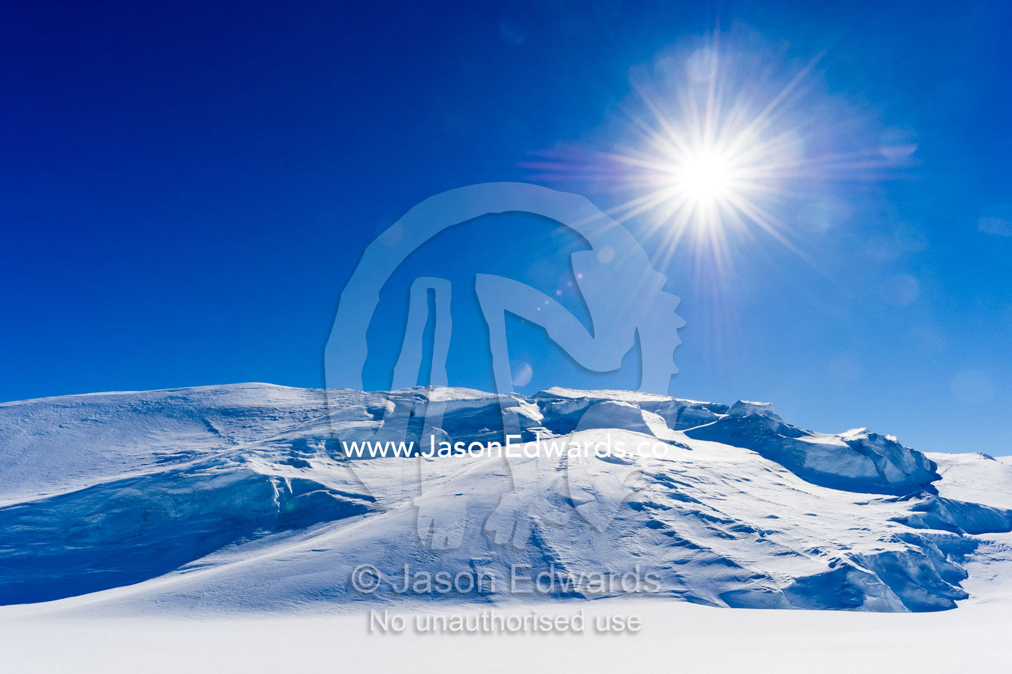 The Antarctic sun rises over a crevasse field above the Ross Ice Shelf. Windless Bight, Ross Ice Shelf, Ross Island, Antarctica.