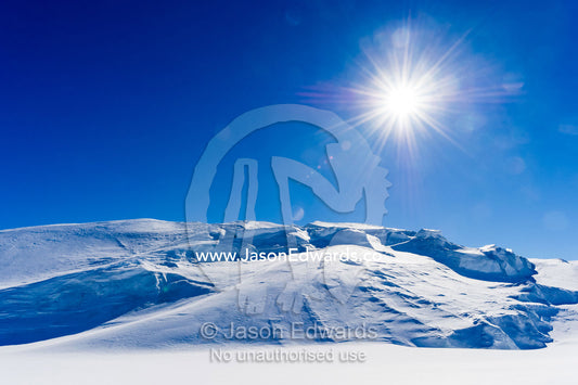 The Antarctic sun rises over a crevasse field above the Ross Ice Shelf. Windless Bight, Ross Ice Shelf, Ross Island, Antarctica.
