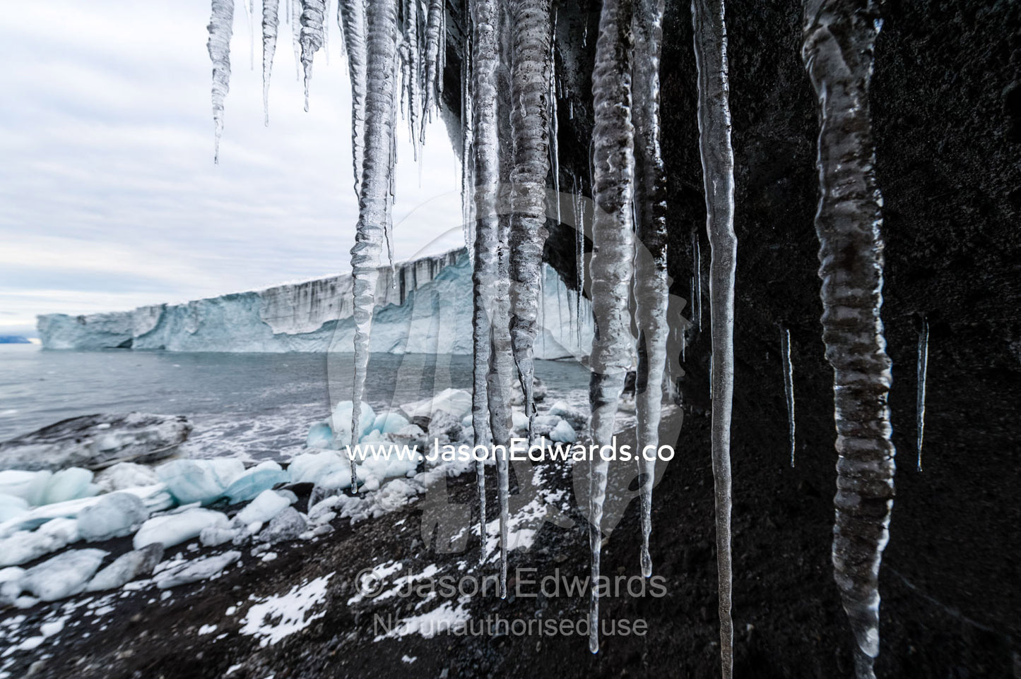 Icicles hang from the tip of a glacier in Antarctica. Cape Bird Ice Cap, Adelie Glacier, Cape Bird, Ross Island, Antarctica.
