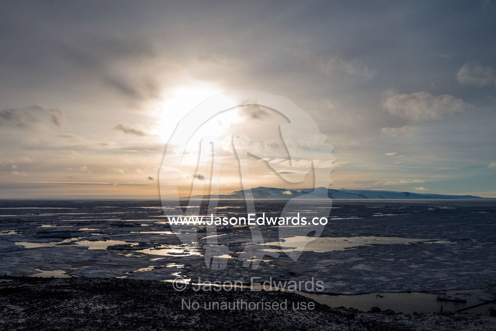The sun reflecting off melt pools in the sea ice during an Antarctic summer. McMurdo Sound, Ross Island, Antarctica.
