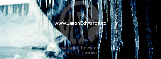 Icicles hang from the tip of a glacier in Antarctica. Cape Bird Ice Cap, Adelie Glacier, Cape Bird, Ross Island, Antarctica.