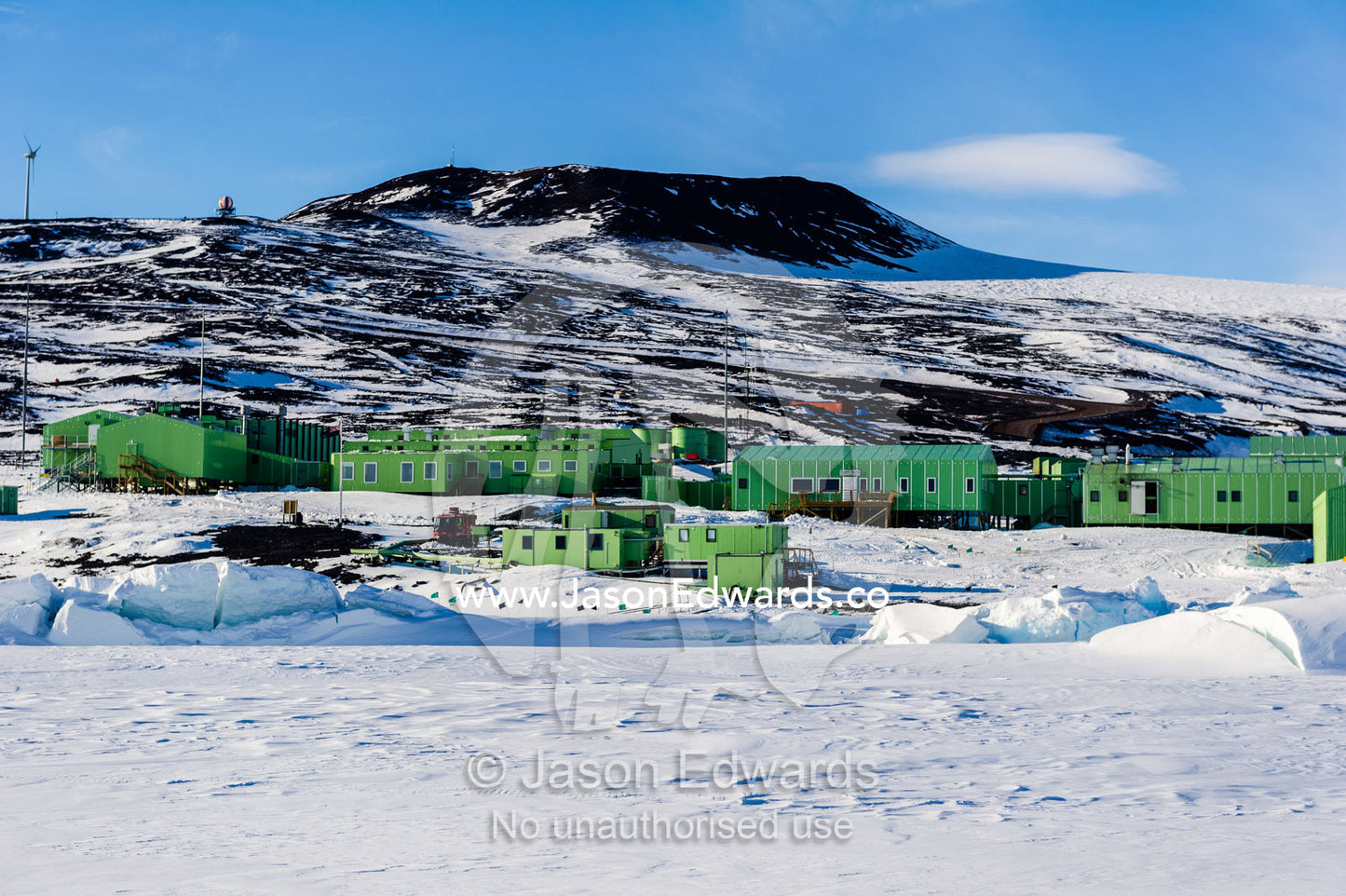 Sea ice pressure ridges rise along the shoreline in front of Scott Base in Antarctica. Scott Base, Pram Point, Hut Point Peninsula, Ross Island, Antarctica.