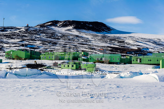 Sea ice pressure ridges rise along the shoreline in front of Scott Base in Antarctica. Scott Base, Pram Point, Hut Point Peninsula, Ross Island, Antarctica.
