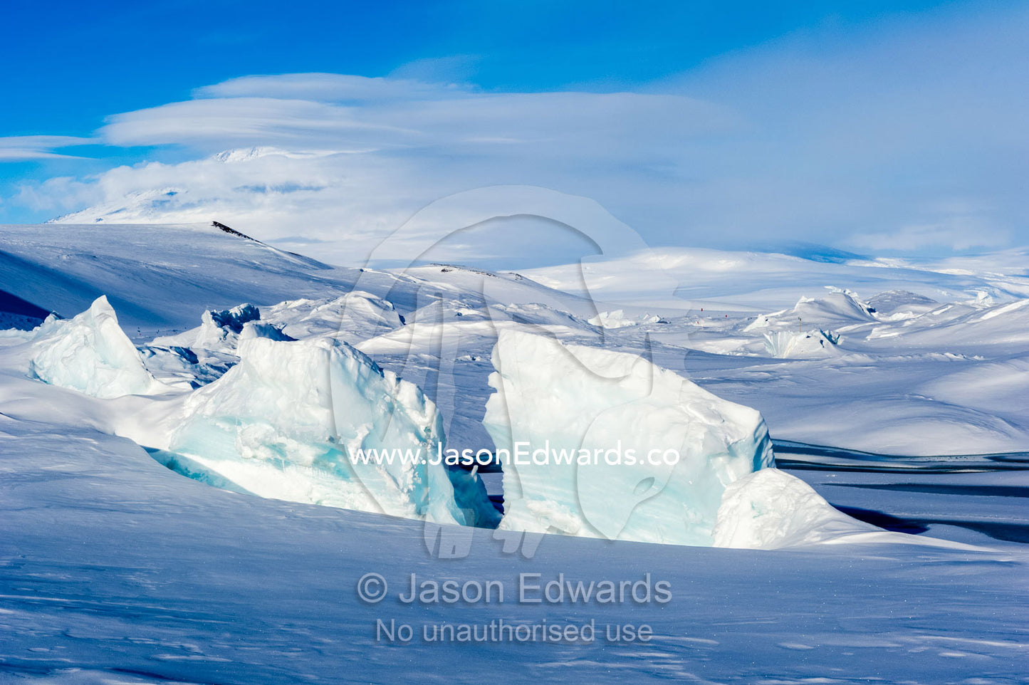 Enormous blocks of ice are pushed skyward along pressure ridges as the sea ice thins and forms melt pools. Pram Point, McMurdo Sound, Ross Island, Antarctica.