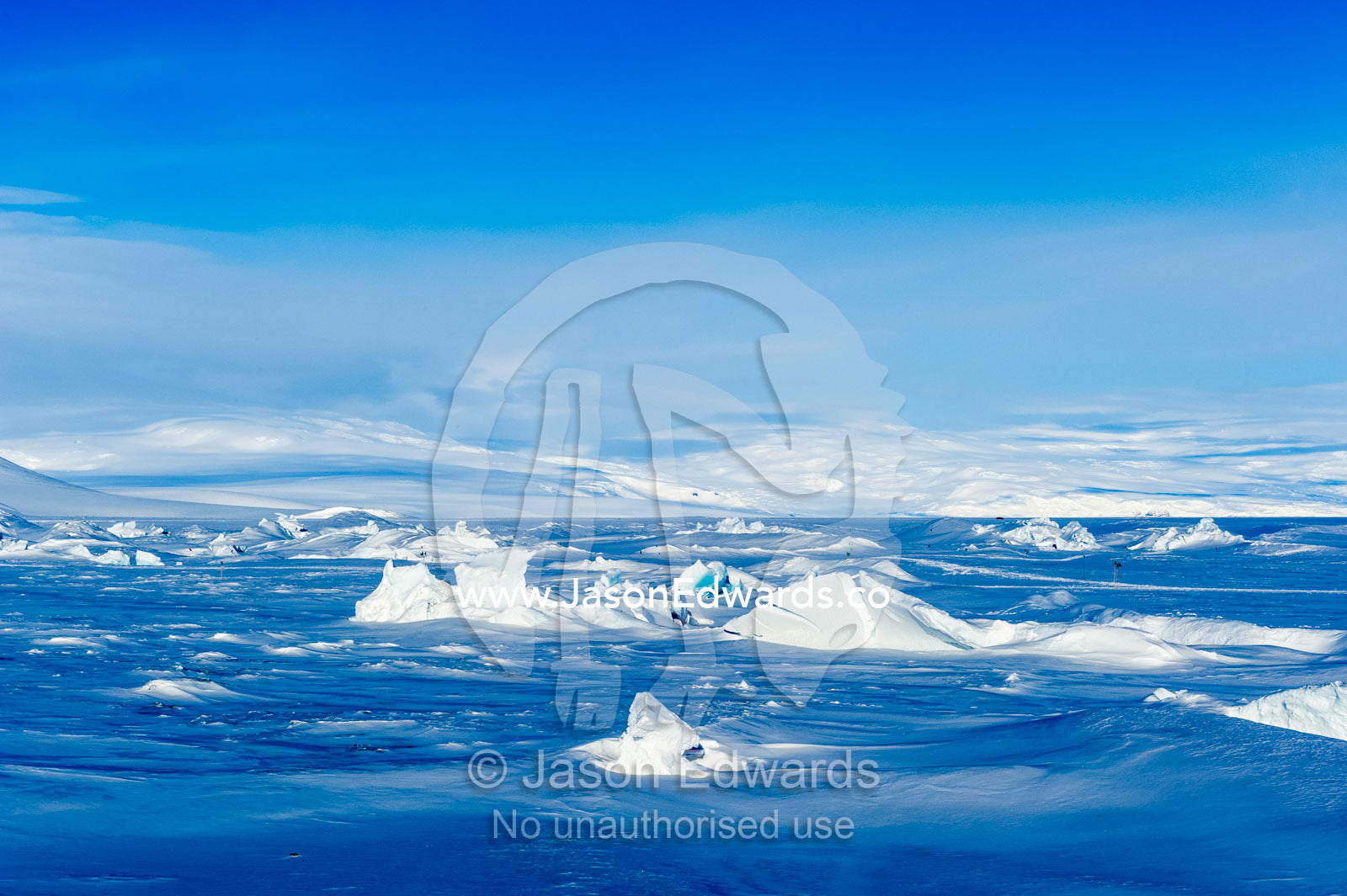 Enormous blocks of ice are pushed skyward along pressure ridges as the sea ice thins and forms melt pools. Pram Point, McMurdo Sound, Ross Island, Antarctica.