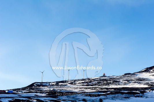 Wind turbines on a barren volcanic hill in Antarctica. Scott Base, Pram Point, Hut Point Peninsula, Ross Island, Antarctica.