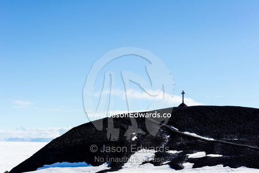 George Vince's Cross on the hill overlooking Discovery Hut in Antarctica. Discovery Hut, Hut Point, Ross Island, Antarctica.
