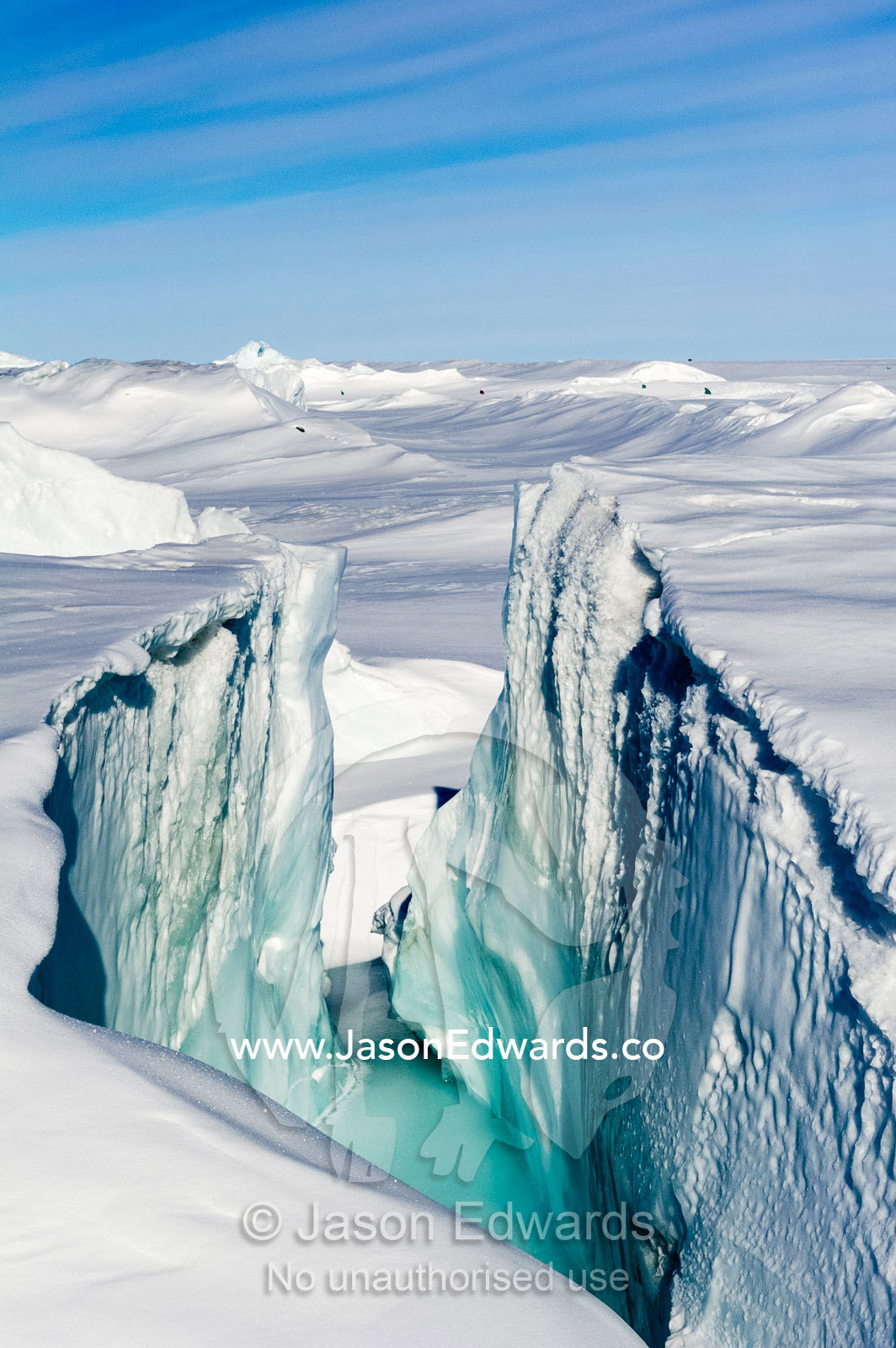 Enormous blocks of ice are pushed skyward along pressure ridges as the sea ice thins and forms melt pools. Pram Point, McMurdo Sound, Ross Island, Antarctica.