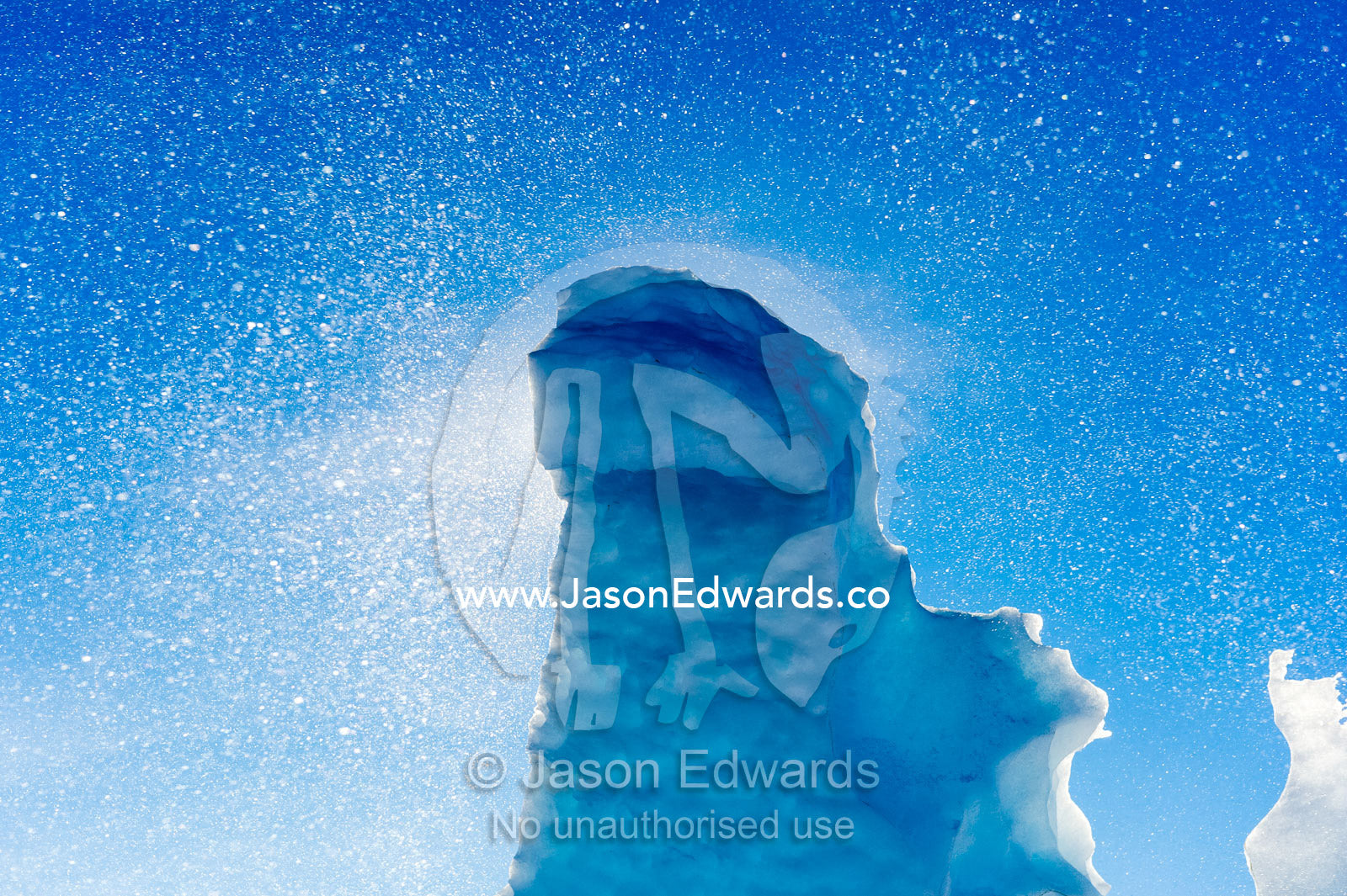 Diamond dust fills the sky above a sea ice pressure ridge pillar in Antarctica. Pram Point, McMurdo Sound, Ross Island, Antarctica.