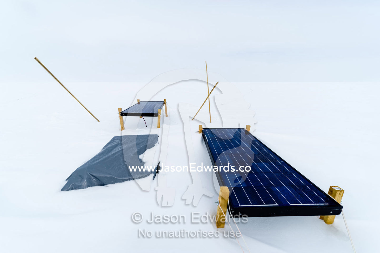 Solar panels on a frozen plain power a volcano research sensor in Antarctica. Windless Bight, Hut Point Peninsula, Ross Island, Antarctica.