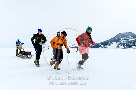 Teams of staff from Antarctic bases compete in a man haul race towing sleds across the frozen sea ice. Cape Armitage, McMurdo Sound, Ross Island, Antarctica.