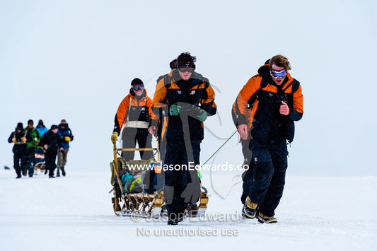 Teams of staff from Antarctic bases compete in a man haul race towing sleds across the frozen sea ice. Cape Armitage, McMurdo Sound, Ross Island, Antarctica.