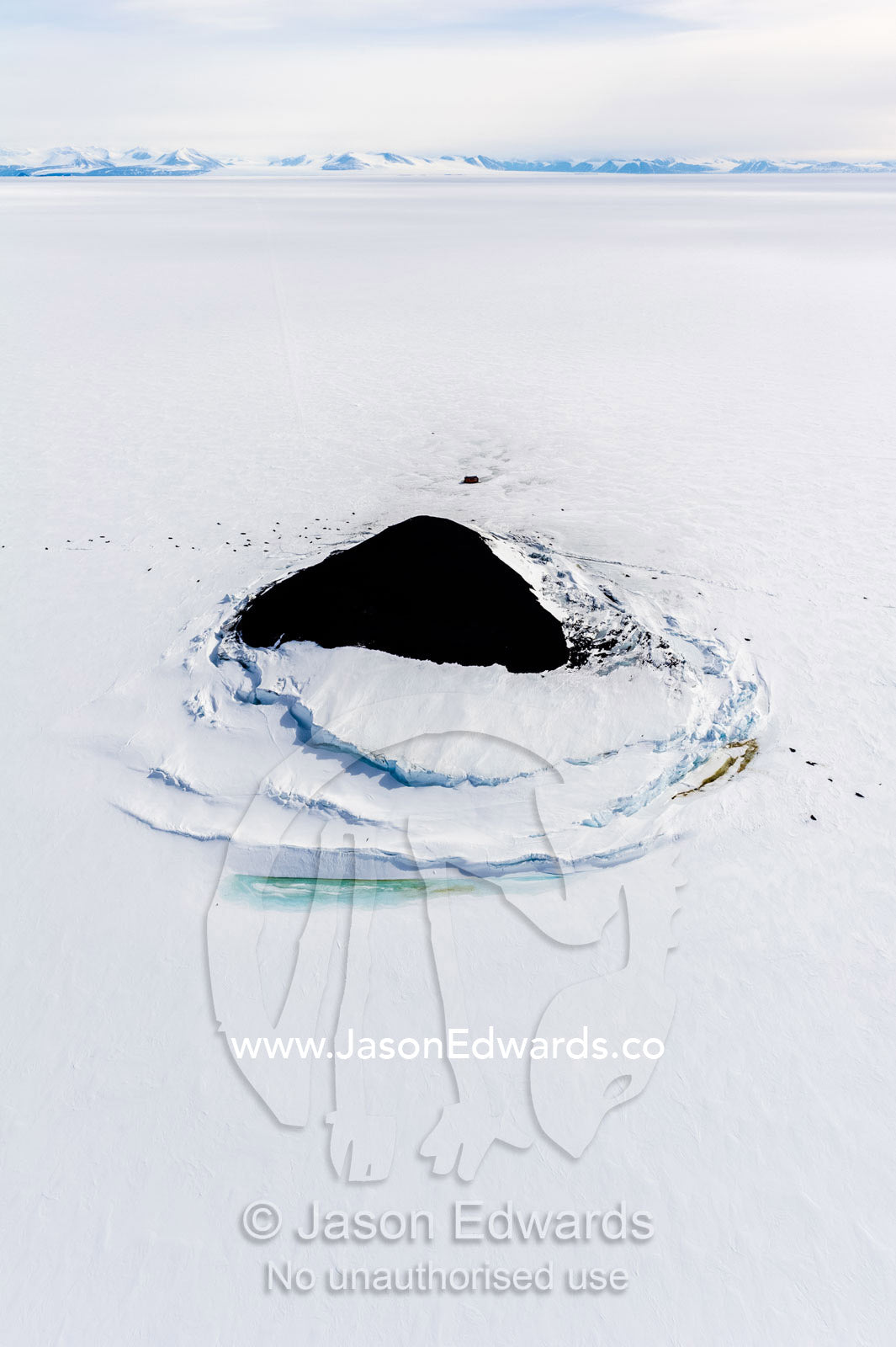 Sea ice pressure ridges rise along the shoreline of a small island in Antarctica. Turtle Rock, Erebus Bay, McMurdo Sound, Ross Island, Antarctica.