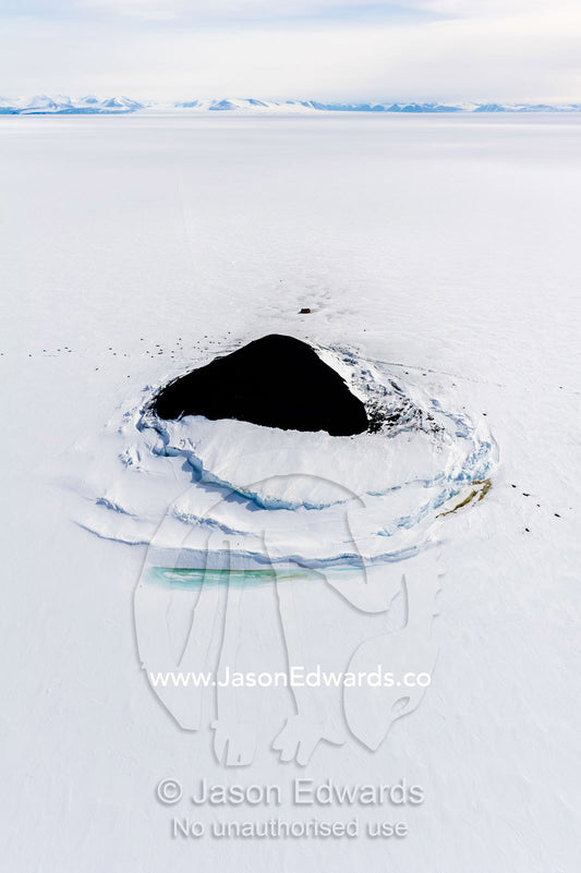 Sea ice pressure ridges rise along the shoreline of a small island in Antarctica. Turtle Rock, Erebus Bay, McMurdo Sound, Ross Island, Antarctica.