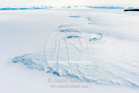 The Erebus Glacier Tongue flows onto the sea ice of the Ross Sea. Erebus Glacier Tongue, Erebus Bay, Tent Island, Ross Island, Antarctica.