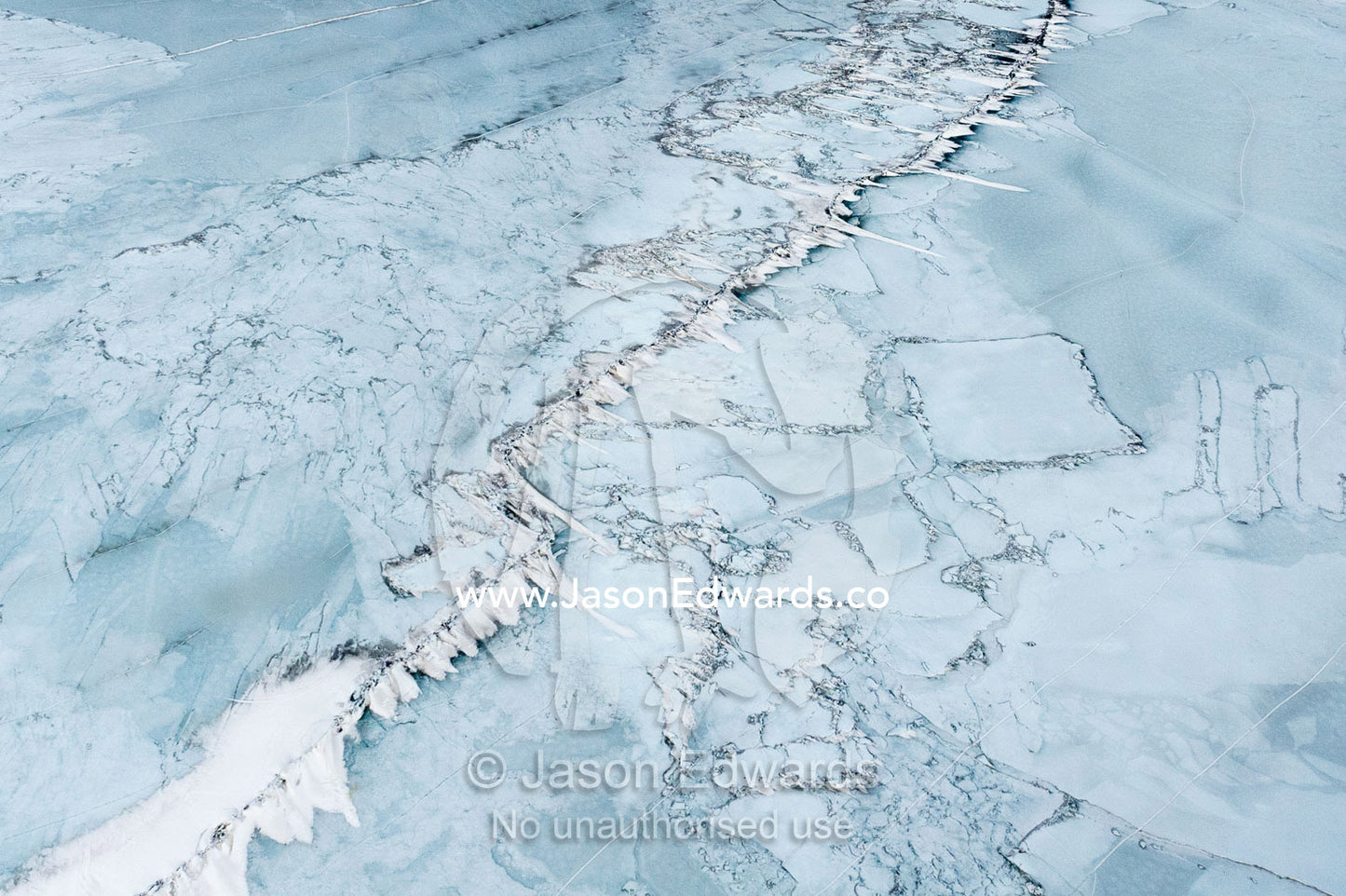 An aerial view of pressure lines and cracks in the frozen sea ice. Erebus Bay, McMurdo Sound, Ross Island, Antarctica.