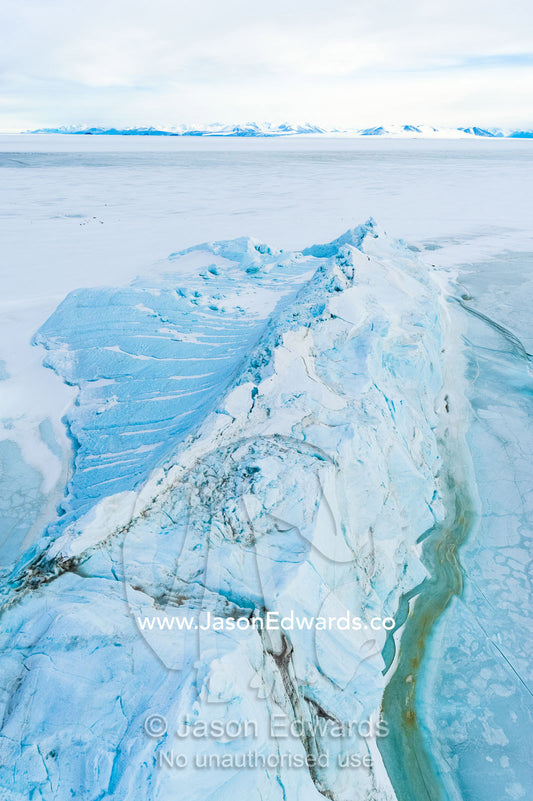 Tortured glacial ice debris separated from the glacier and fallen into the sea ice. Descent Cliffs, Erebus Bay, McMurdo Sound, Ross Island, Antarctica.