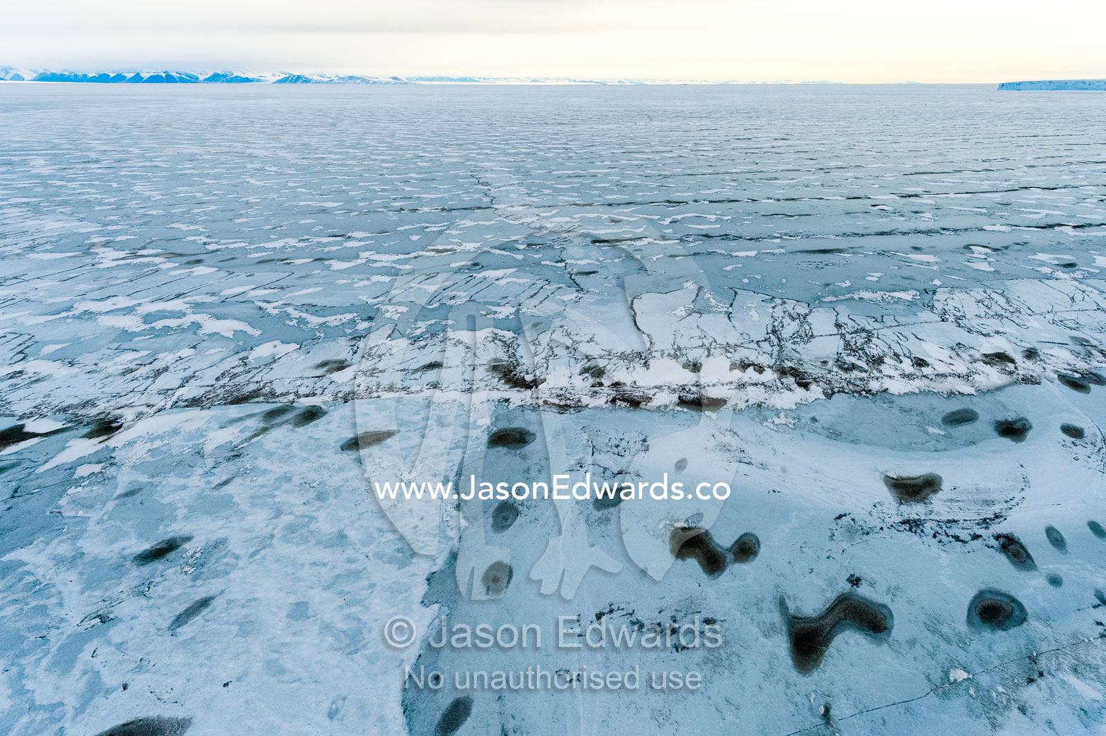 Melt pools and cracks appearing in the sea ice of the Ross Sea. North Bay, Cape Evans, Ross Sea, Ross Island, Antarctica.