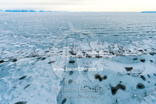 Melt pools and cracks appearing in the sea ice of the Ross Sea. North Bay, Cape Evans, Ross Sea, Ross Island, Antarctica.