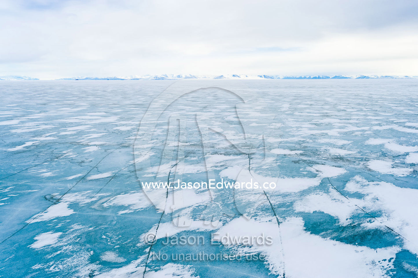 Snow drifts gather on the surface of the sea ice of the Ross Sea. North Bay, Cape Evans, Ross Sea, Ross Island, Antarctica.