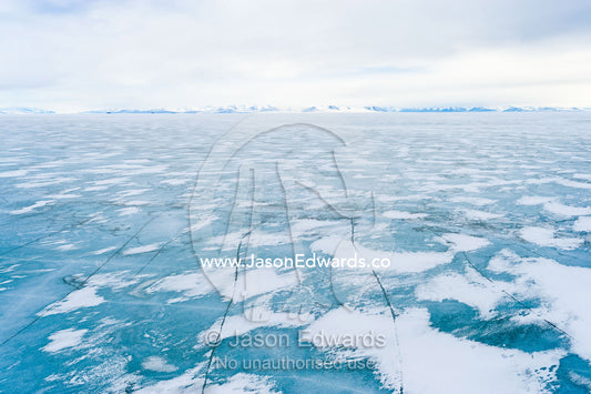 Snow drifts gather on the surface of the sea ice of the Ross Sea. North Bay, Cape Evans, Ross Sea, Ross Island, Antarctica.
