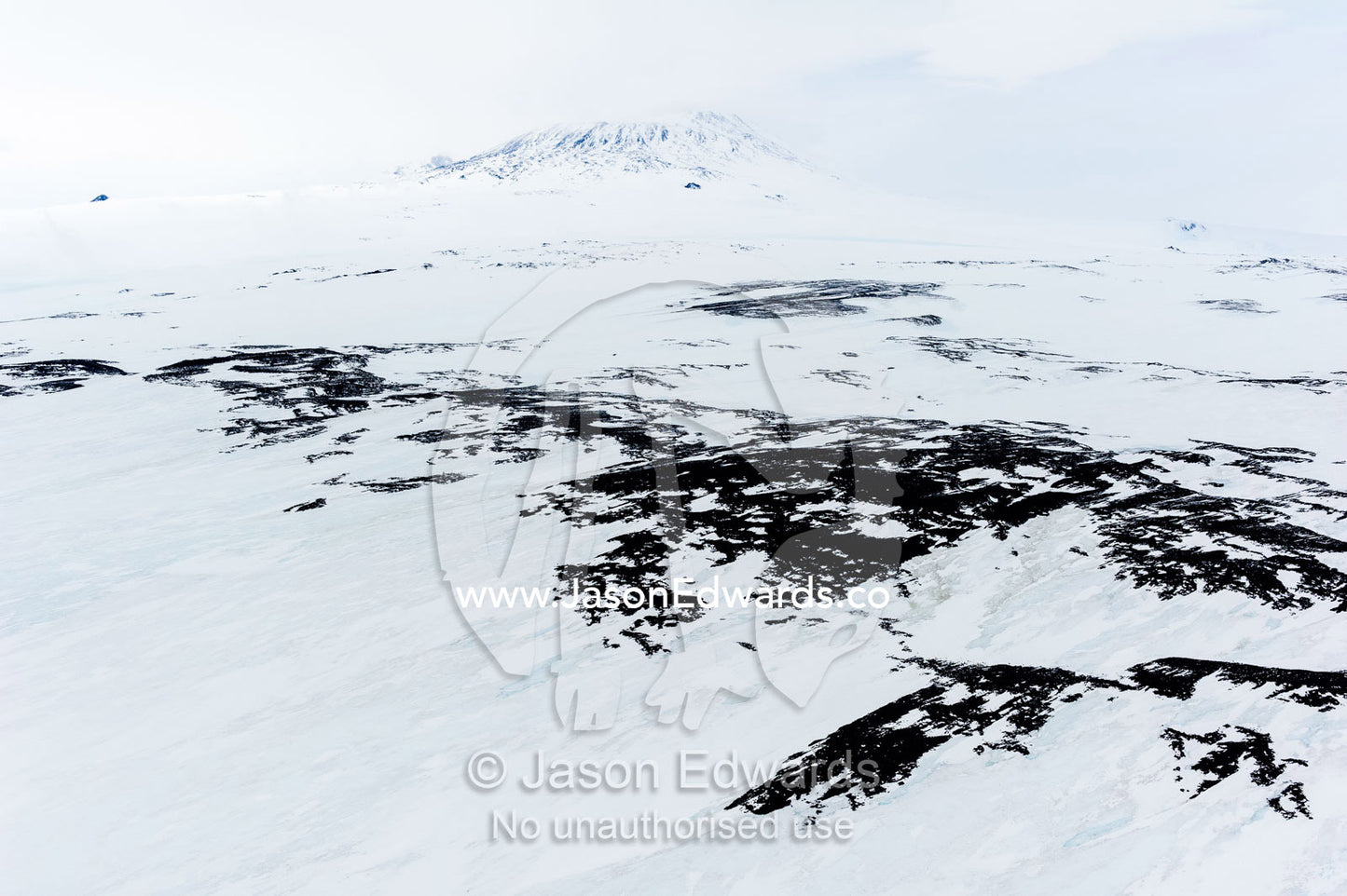 Ice sheets and snow cover the slopes of Mount Erebus an active volcano. Cape Royds, Mount Erebus, Ross Island, Antarctica.