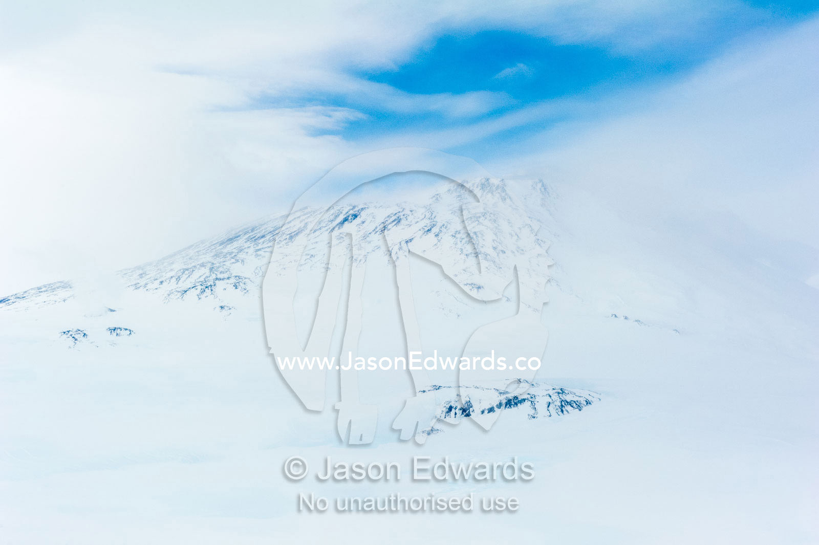 Ice sheets and snow cover the slopes of Mount Erebus an active volcano. Mount Erebus, Ross Island, Antarctica.
