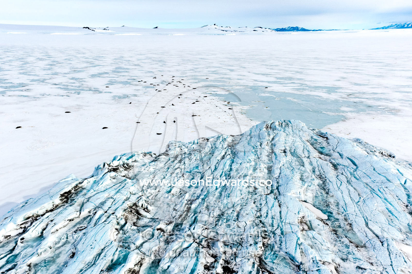 The fractured and tortured ice tongue of the Mt Erebus Glacier sweeps off the slopes of the active volcano. Pakaru Icefalls, South Bay, Ross Island, Antarctica.