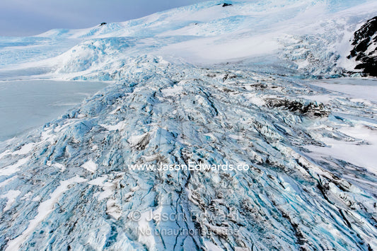 The fractured and tortured ice tongue of the Mt Erebus Glacier sweeps off the slopes of the active volcano. Pakaru Icefalls, South Bay, Ross Island, Antarctica.
