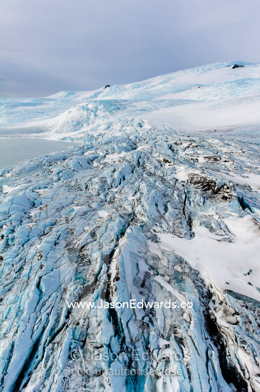 The fractured and tortured ice tongue of the Mt Erebus Glacier sweeps off the slopes of the active volcano. Pakaru Icefalls, South Bay, Ross Island, Antarctica.