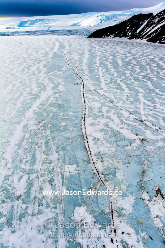 Cracks and pressure ridges in the sea ice provide access for Weddell Seals to the ocean. Turks Head, Turks Head Bay, Ross Island, Antarctica.